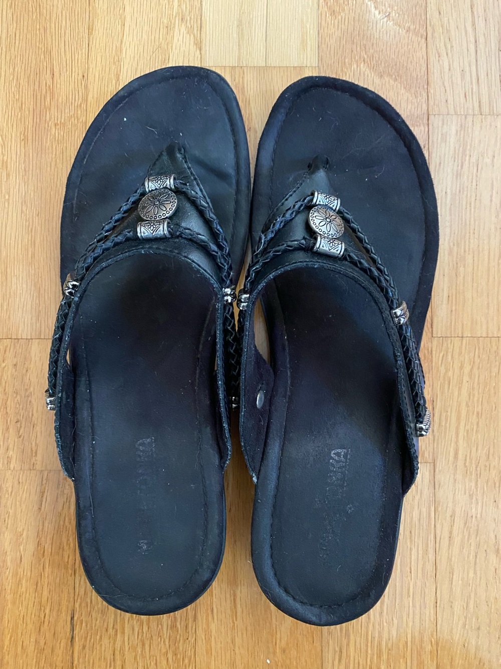 Minnetonka Black Braided Thong Sandals with Silver Medallions